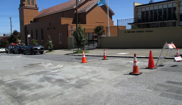Though it doesn't look it, there is a hump of paving between the cones. Hearst Ave just west of Edna Street.
